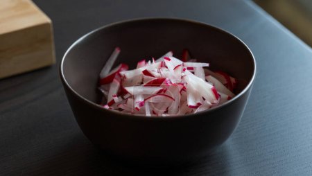 crunchy radish delight: fresh slices in brown bowl close-up