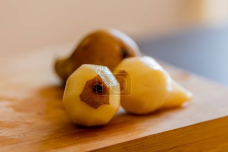 delicious peeled pears close-up on wooden board 