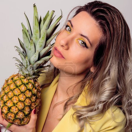 beautiful blonde woman with yellow makeup and pineapple creative makeup 