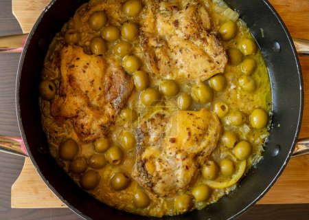Delicious Mediterranean Chicken Thighs with Lemon and Green Olives Close Up 