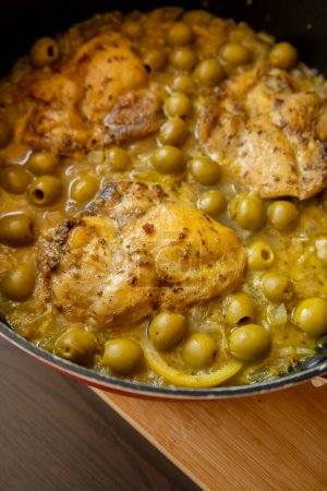 Delicious Mediterranean Chicken Thighs with Lemon and Green Olives Close Up 