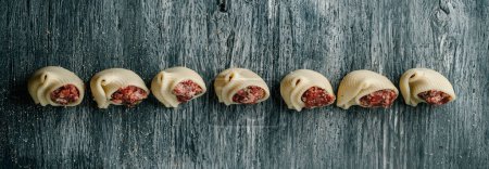 Photo for High angle view of some galets filled with ground meat, to prepare sopa de galets or escudella de Nadal, typically eaten on Christmas in Catalonia, Spain, in a panoramic format to use as web banner - Royalty Free Image