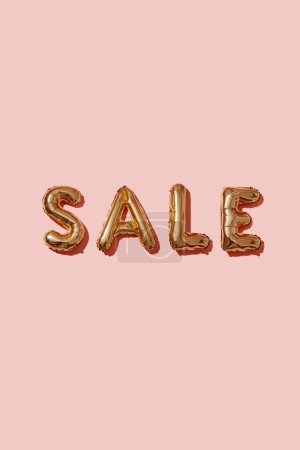 Photo for Closeup of some golden letter-shaped balloons forming the word sale on a pink background - Royalty Free Image