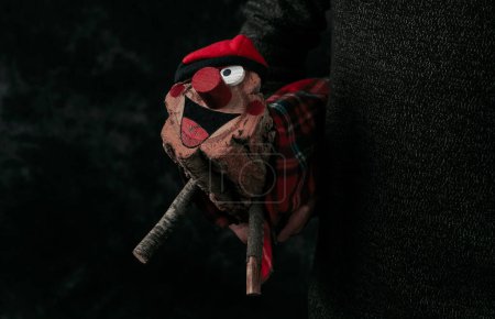Photo for A man carries a homemade catalan tio de nadal, a magical christmas character, typical of catalonia, spain, wearing a barretina, a red cap also typical of catalonia - Royalty Free Image