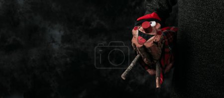 Photo for A man carrying a homemade catalan tio de nadal, a magical christmas character, typical of catalonia, spain, in na panoramic format to use as web banner or header - Royalty Free Image