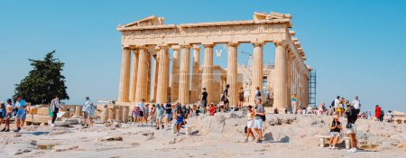 Photo for Athens, Greece - August 30, 2022: A crowd of visitors observe the remains of the famous Parthenon, in the Acropolis of Athens, Greece, in a panoramic format - Royalty Free Image