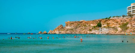 Photo for Mellieha, Malta - September 5, 2022: A panoramic view over the Golden Bay, in Mellieha, Malta, where some people is bathing in its calm seawater - Royalty Free Image