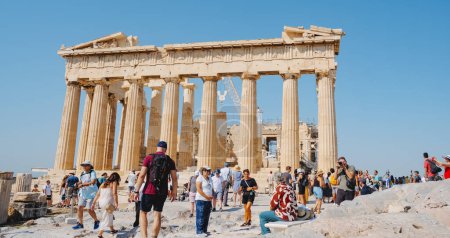 Photo for Athens, Greece - August 30, 2022: A crowd of visitors walking by the Acropolis of Athens, Greece, in front of the remains of the famous Parthenon, - Royalty Free Image