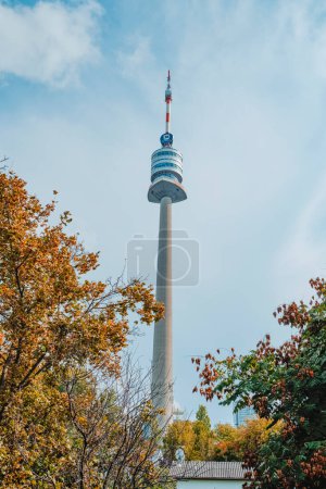Photo pour Vienna, Austria - August 28, 2022: A view of the telecommunications tower Donauturm, or Danube Tower, in Donaustadt district in Vienna, Austria, emerging among the trees - image libre de droit