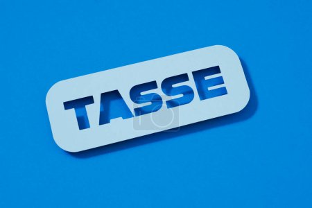 Photo for A pale blue paper sign with the text taxes written in italian, on a blue background - Royalty Free Image