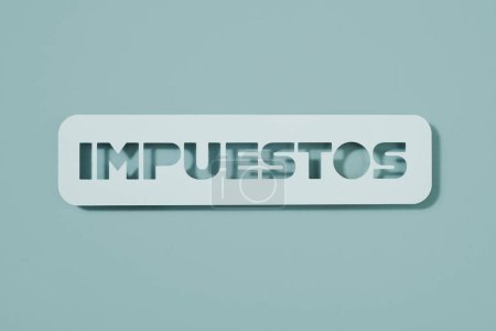 Photo for A pale blue paper sign with the text taxes written in spanish, on a pale blue background - Royalty Free Image