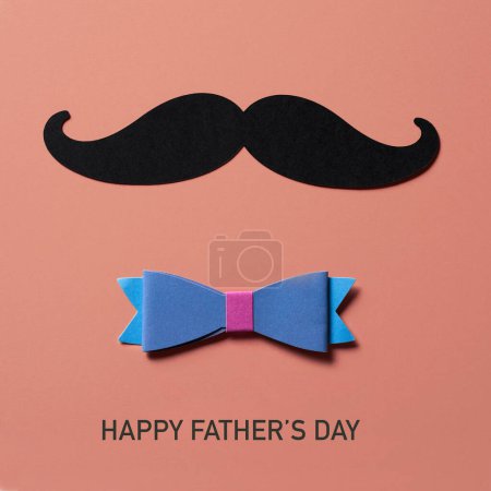 Photo for A moustache, made with a cutout of a black cardboard, a multicolored bow tie and the text happy fathers day on a pink background - Royalty Free Image