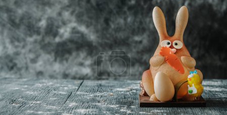 Photo for A white chocolate easter bunny as a spanish mona de pascua, a traditional confection given by godparents to godchild on easter, in a panoramic format to use as web banner - Royalty Free Image