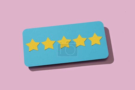 Photo for Closeup of a blue sign with five stars, from a five star rating scale, on a pink background - Royalty Free Image