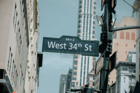 Photo for Detail of a West 34th Street sign in Midtown Manhattan, in New York, United States, on a sunny spring day - Royalty Free Image