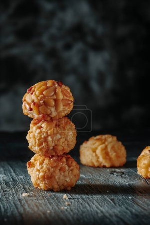 Photo for Closeup of a stack of panellets, a marzipan confection typical of Catalonia, Spain, eaten traditionally on All Saints Day, on a gray rustic table - Royalty Free Image