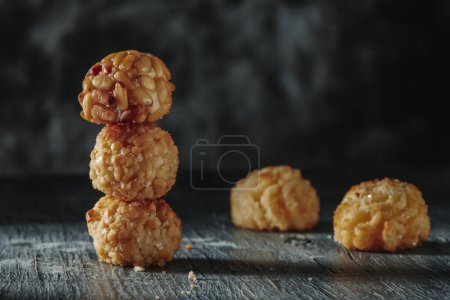 Photo for A stack of panellets, a typical confection of Catalonia, Spain, eaten traditionally on All Saints Day, on a gray rustic table - Royalty Free Image