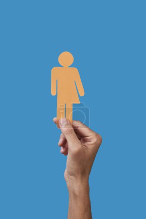 Photo for Closeup of a man holding a homemade yellow gender neutral icon in his hand - Royalty Free Image