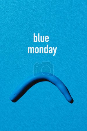 Photo for The text blue monday and a sad mouth made with blue modelling clay on a blue leather background - Royalty Free Image