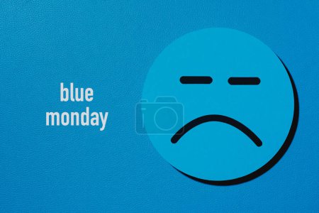 Photo for The text blue monday and a sad face on a blue background - Royalty Free Image