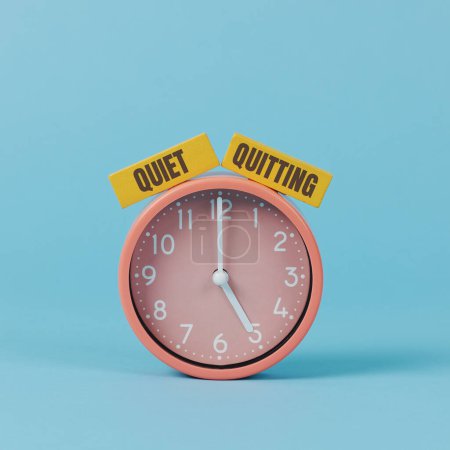 Photo for The text quiet quitting written on two yellow rectangular pieces, on a pink clock striking five, on a blue background - Royalty Free Image