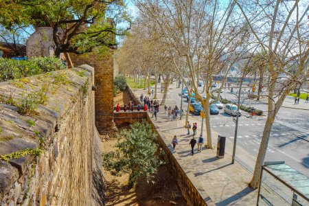 Photo for Barcelona, Spain - March 17, 2024: The walls of Les Drassanes Bastion, and Gate of Santa Madrona, in Parallel Avenue in Barcelona, Catalonia, Spain - Royalty Free Image