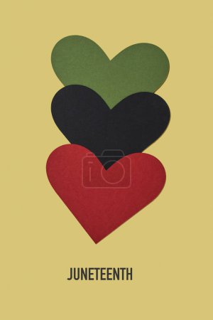 the text juneteenth and three hearts with the colors of the black liberation flag, green, black and red, aka afro-american flag