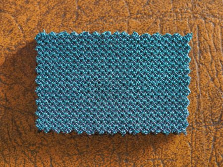 Photo for Industrial style blue green a fabric swatch with zig zag border cut with pinking shears - Royalty Free Image