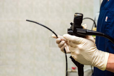 Photo for Endoscope in the hands of doctor. Medical instruments used in gastroscopy. - Royalty Free Image