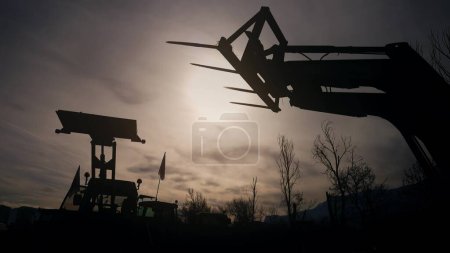 Protest of the farmers. Silhouette of an agricultural forklift