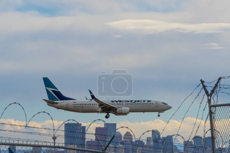 Photo for 19 February 2024 - Calgary Alberta Canada - West Jet 737 arriving at Calgary Airport - Royalty Free Image