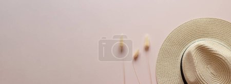 Photo for Banner with straw hat and lagurus against beige background. Copy space. Fashion concept. Summer concept. Top view. - Royalty Free Image