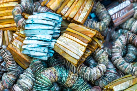 Photo for Colorful bracelet with decorative stones and shells. Souvenirs exhibited in market shops of the old town Nizwa. Oman. Arabian Peninsula. - Royalty Free Image