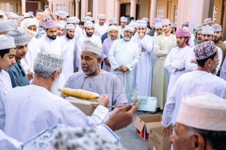 Photo for NIZWA, OMAN - NOVEMBER 18, 2022: Nizwa Goat Market. Traditional natural honey auction at Nizwa, Oman. - Royalty Free Image