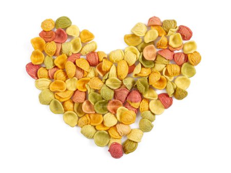 Photo for Coloured raw pasta arranged as a heart isolated on white background - Royalty Free Image
