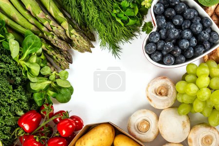 healthy fruits and vegetables isolated on white background arranged as a frame for your text
