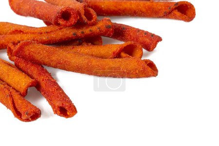 Foto de Pile of spicy corn chips isolated on white background. Hot rolled chips. - Imagen libre de derechos