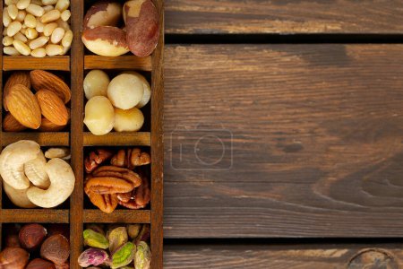 Photo for Assortments of nuts on wooden surface - Royalty Free Image