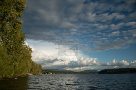 Quiet sunset  on Sammamish Lake with  variety of cloud formations in blue sky