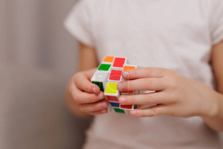 Photo for Close up of colorful Rubik's cube in little girl's hands - Royalty Free Image