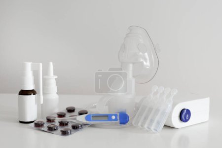 Photo for Inhaler, digital thermometer, nasal spray and pills - Royalty Free Image