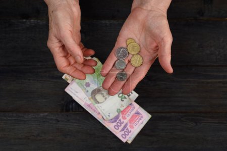 the woman considers the Ukrainian hryvnia. A concept showing the Ukrainian economy.