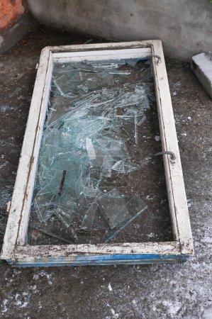 Photo for A broken old window. Broken glass on the floor - Royalty Free Image