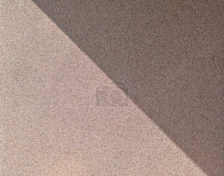 Photo for A diagonal shadow on the wall. finishing with granite chips - Royalty Free Image
