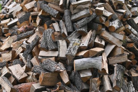 Natural biological fuel from chopped wooden logs. Background