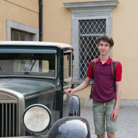Photo for Handsome cheerful teen boy near retro car, summer outdoor - Royalty Free Image