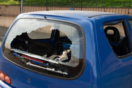 Photo for Rear and side glass shattered in car parked in street parking. Thieves broke the glass in the automobile - Royalty Free Image
