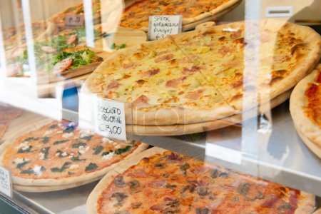 Photo for Different types of pizza are sold in a street food cafe in Italy - Royalty Free Image