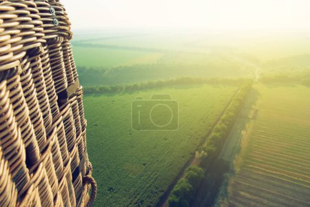 Photo for Amazing view from the height of the balloon. View from the balloon's basket. Summer beautiful fields lanscape from the bird's eye, sunrise. Ballooning. - Royalty Free Image