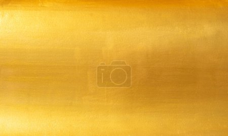 Gold Wand Textur Hintergrund. Gelb glänzende Goldfolienfarbe auf Wandfolie mit Glanzlichtreflexion, lebendige goldene Luxus-Tapete